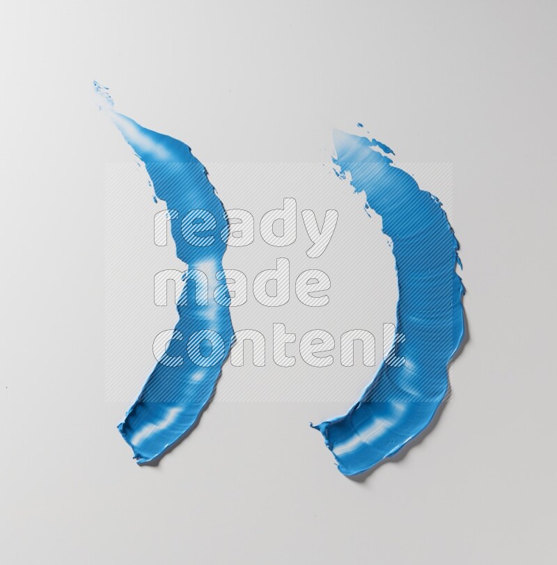 Blue curved painting knife strokes on white background
