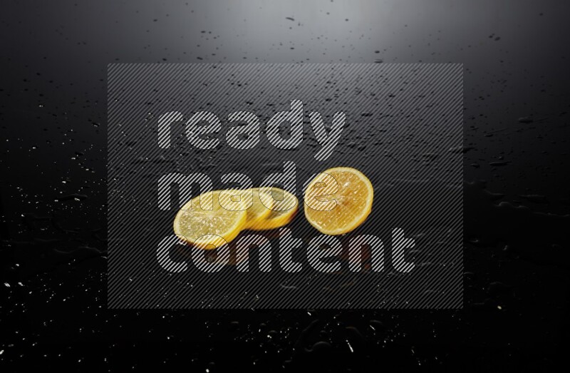 Lemon slices with water drops, and droplets on black background