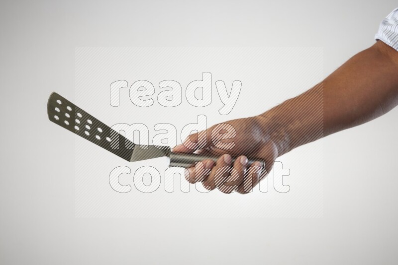 Male Hand Holding Burger Flipper on white background