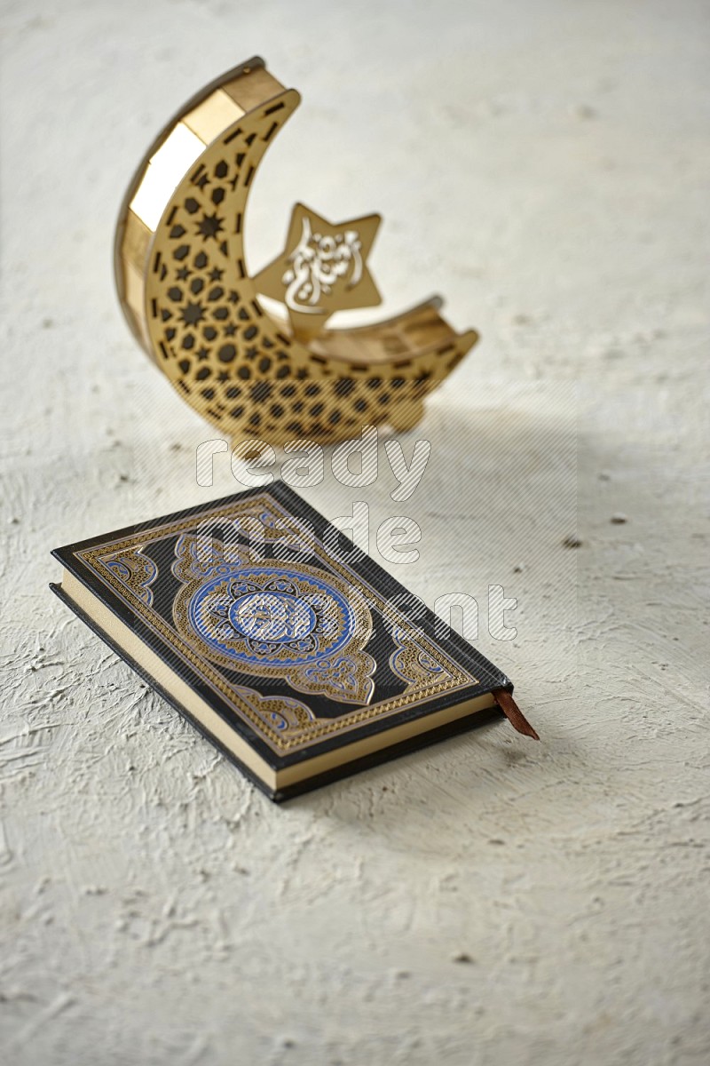 A crescent lantern with drinks, dates, nuts, prayer beads and quran on textured white background