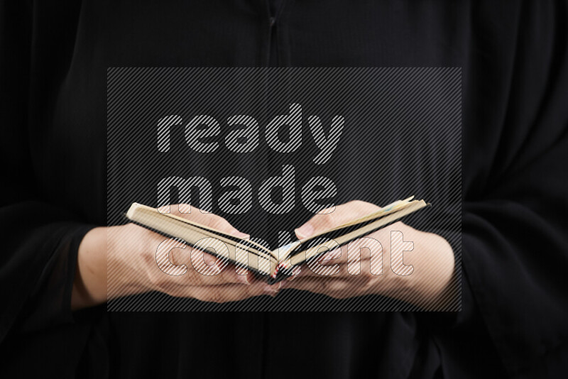 A woman hands holding moshaf in different positions