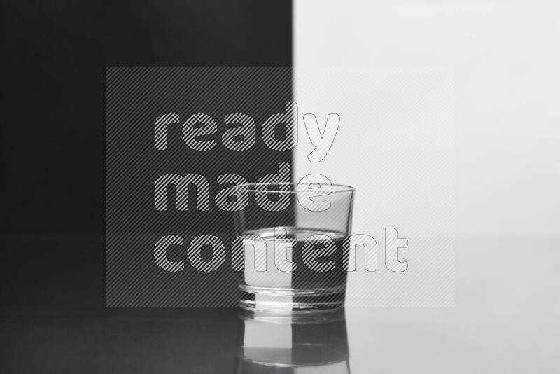 The image features a clear glassware filled with water, set against white and black background