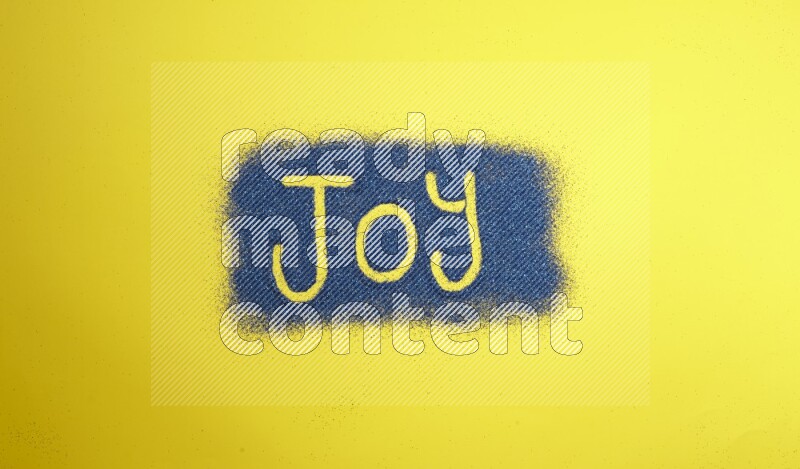A word written with blue glitter on yellow background