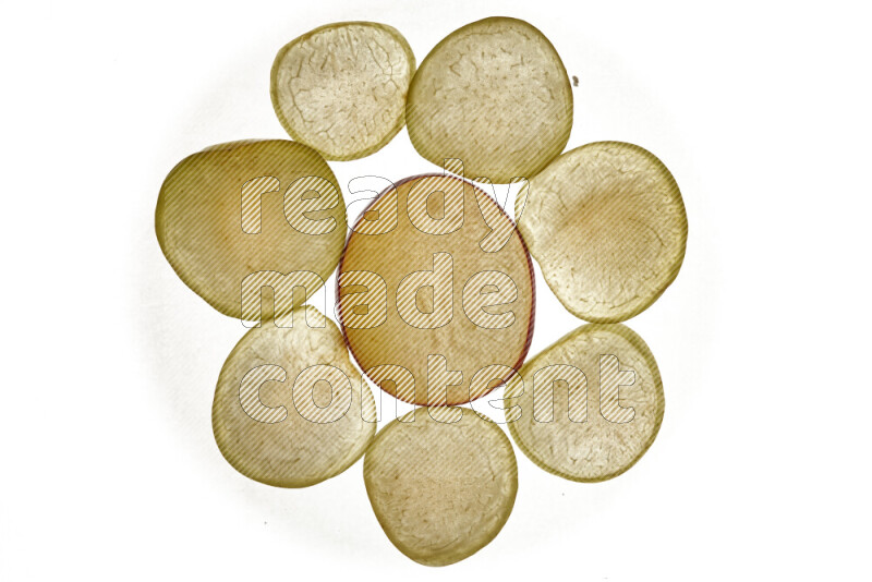 Plum slices on illuminated white background