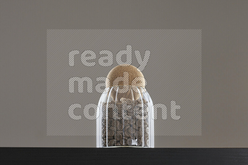 Buttons in a glass jar on black background