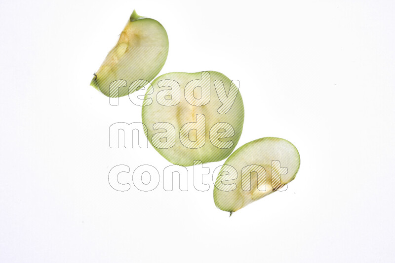 Apple slices on illuminated white background