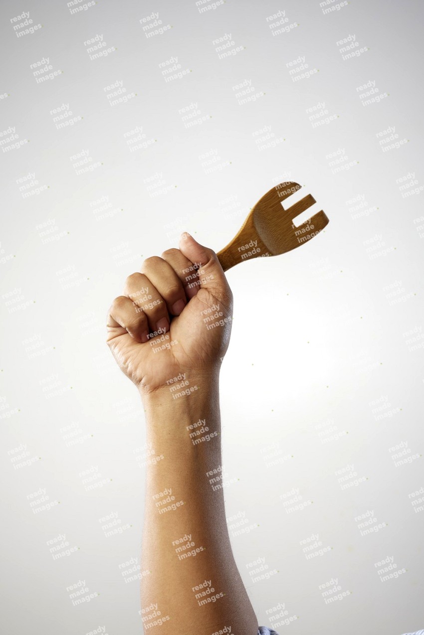 Male Hand Holding Wooden Fork on white  background