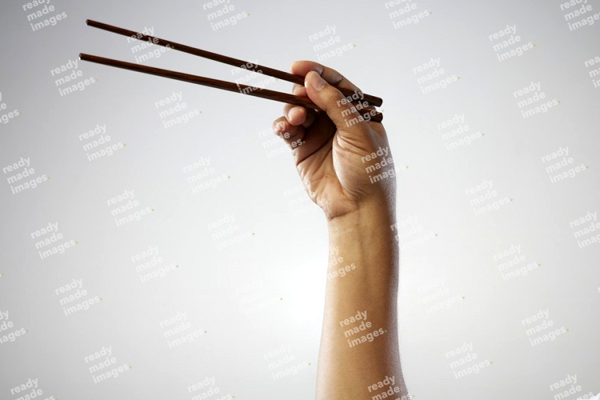 Male Hand Holding Chop Stick on white background
