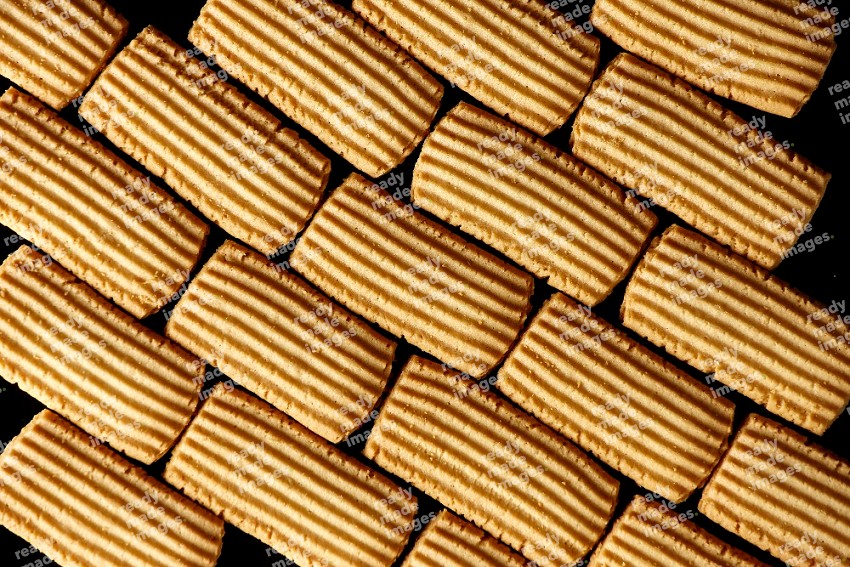 Top View of Plain Tea Biscuits Cookies filling the frame on Black Flooring
