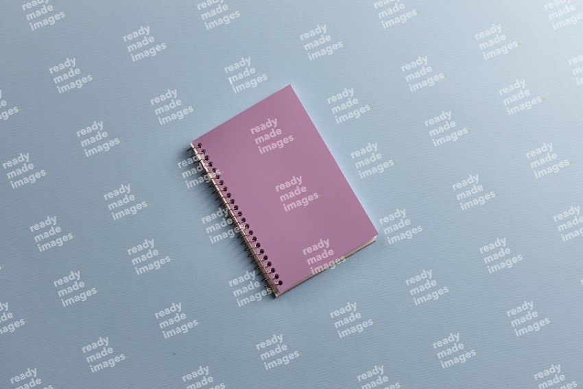 A purple notebook on blue background (Back to school)