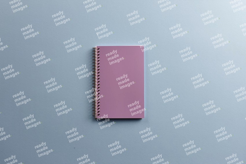 A purple notebook on blue background (Back to school)