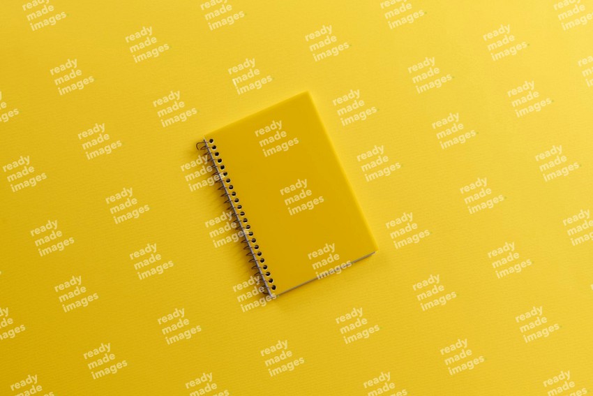 A yellow notebook on yellow background (Back to school)