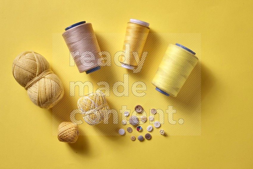 Yellow sewing supplies on yellow background