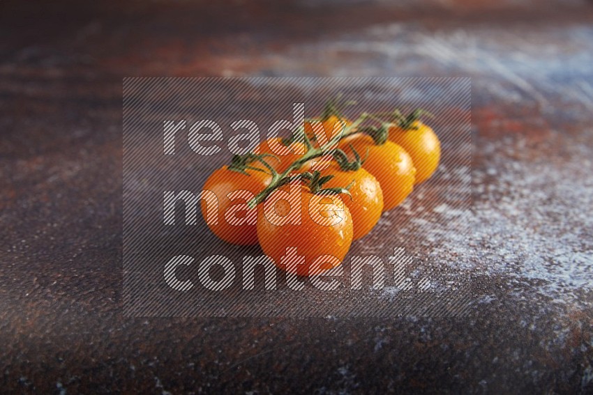 Orange cherry tomato vein on reddish rustic metal background 45 degree