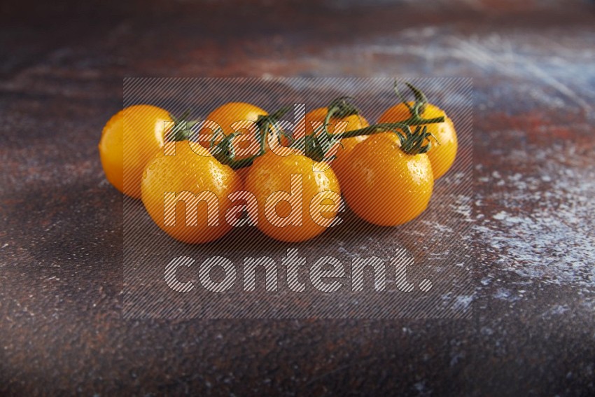 Yellow cherry tomato vein on reddish rustic metal background 45 degree