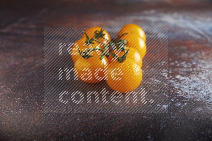 Yellow cherry tomato vein on reddish rustic metal background 45 degree