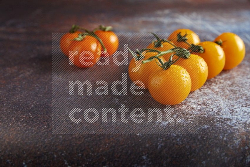Mixed cherry tomato veins on a textured reddish rustic metal background 45 degree