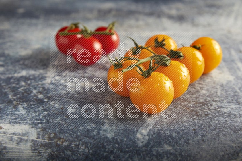Mixed cherry tomato veins on a textured rustic blue background 45 degree